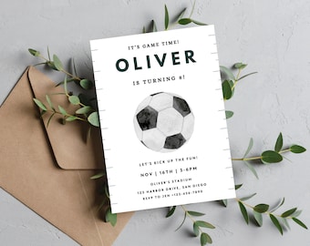 May include: A white and black soccer ball with a watercolor effect is featured on a white invitation card. The invitation is for Oliver's 8th birthday party. The text reads "It's game time! Oliver is turning 8! Let's kick up the fun! Nov 16th | 3-6pm Oliver's Stadium 123 Harbor Drive, San Diego RSVP to Jen +123-456-7890"