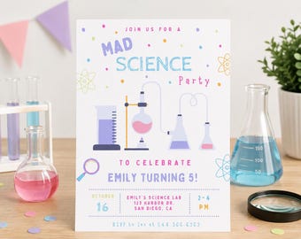 May include: A rectangular party invitation card with a white background featuring colorful science-themed graphics including beakers, flasks, and atoms. The text reads: JOIN US FOR A MAD SCIENCE PARTY TO CELEBRATE EMILY TURNING 5! OCTOBER 16, 2-4 PM.
