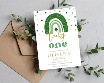 May include: A green and gold invitation with a rainbow and shamrocks. The text reads "Lucky One" and "Oliver's First Birthday".