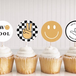 May include: Four cupcakes with different toppers. The toppers are round and feature a peace sign, a smiley face, the words "TWO COOL" with a smiley face, and a hand making a "hang loose" gesture with the words "Let's Party Happy Birthday".