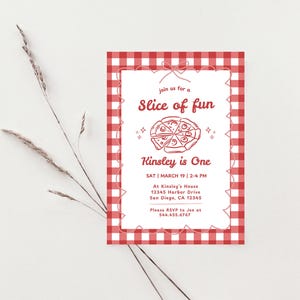 May include: A red and white gingham-patterned invitation with the text "Slice of fun" and "Kinsley is One." The invitation includes event details and a pizza graphic. A sprig of dried grass is in the background.