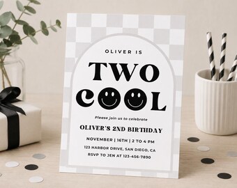 May include: A rectangular birthday invitation card featuring a light gray and white checkered background with a central arch design. The text reads: OLIVER IS TWO COOL, Please join us to celebrate, OLIVER'S 2ND BIRTHDAY, NOVEMBER 16TH, 2 TO 4 PM.
