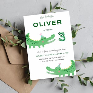May include: A green and white birthday invitation with a cartoon alligator wearing a party hat. The invitation says "Oh Snap! Oliver is turning 3. Join us for a chomping good time Saturday | October 21 | 2 PM to 4 PM 123 Harbor Drive, San Diego, CA RSVP to Jen at 4334555667"