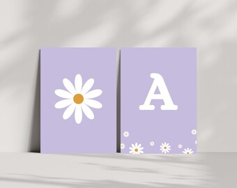 May include: Two printable wall art prints with a light purple background. The first print features a white daisy with a yellow center. The second print features the letter A in white with a scattering of white daisies at the bottom.