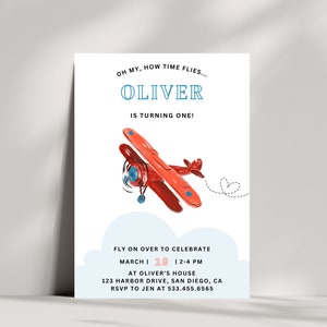 May include: A white invitation card with the text "OH MY, HOW TIME FLIES... OLIVER IS TURNING ONE!" features a red airplane illustration. The card also includes event details: "FLY ON OVER TO CELEBRATE" and the date, time, and location.
