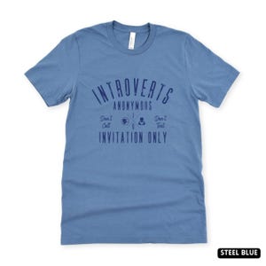 May include: A white ceramic mug with a black handle and the text "But First, Coffee" in a handwritten style. The mug is on a white surface. The mug is 10 cm tall.