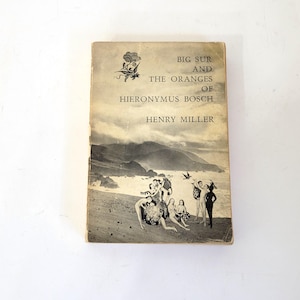 May include: Vintage book titled "Big Sur and the Oranges of Hieronymus Bosch" by Henry Miller. The cover features a black and white illustration of a coastal scene with figures. The book has a worn, aged appearance.