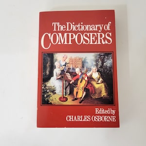 May include: A red book titled "The Dictionary of Composers" with white text. The cover features a colorful illustration of musicians playing instruments in a garden setting. Edited by Charles Osborne.