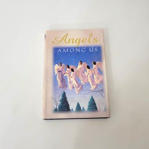 May include: A book titled "Angels Among Us: A Guideposts Book" with a cover image of seven angels with white wings and flowing white robes flying over a forest scene.