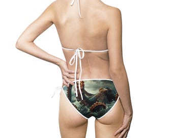 May include: White bikini bottoms with a graphic print of an octopus emerging from the water.