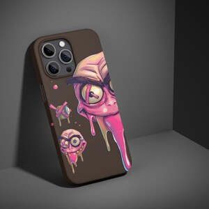 May include: A brown phone case with a pink and purple cartoon face with a dripping tongue. The case has a camera cutout and a black background.