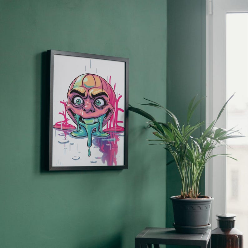 May include: A framed illustration of a cartoon face with a green dripping substance coming from its mouth. The face is pink, yellow, and blue with a white background.