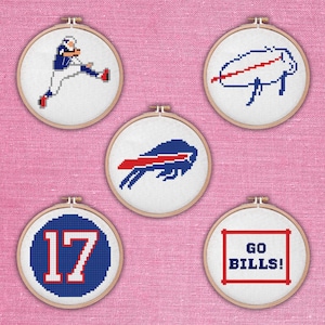 May include: Five cross-stitch embroidery hoops featuring Buffalo Bills designs. Includes a player kicking a football, the team logo, the number 17, and the words "GO BILLS!" in red and blue on a white background.