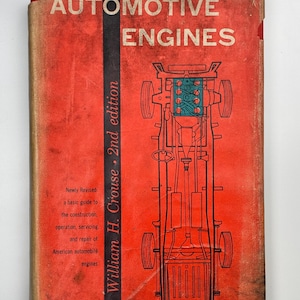 May include: A vintage book titled "AUTOMOTIVE ENGINES" with a red cover and a detailed illustration of a car's engine and chassis. The book is the 2nd edition by William H. Crouse, offering a guide to American automobile engines.
