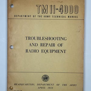 May include: A vintage technical manual titled "TM 11-4000" with the text "Troubleshooting and Repair of Radio Equipment." The cover is a light brown colour with black text and the Department of the Army seal. Published in April 1958.
