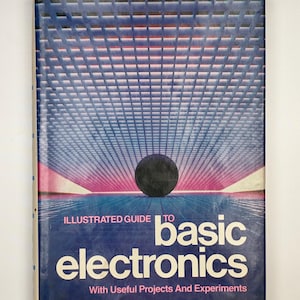 May include: A vintage book titled "Illustrated Guide to Basic Electronics" with a blue and pink geometric cover design. The cover features a dark sphere and the author's name, John P. Steiner.