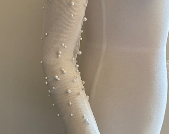May include: White sheer fabric sleeve with white pearl embellishments.