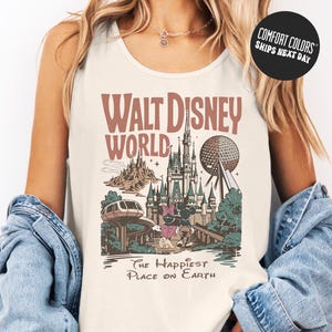 A woman wearing a white tank top with a graphic of Walt Disney World and the text "The Happiest Place on Earth" printed on it.