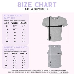 The image is a size chart for women's crop baby t-shirts. It provides measurements for different sizes, including XS, S, M, L, XL, and 2XL. The chart includes a warning that the front of the shirt should be laid flat and the width of the shirt should be measured from the highest point of shoulder to the bottom hem, and that the shirt should be allowed to be 1 1/2" taller than the wearer's height.