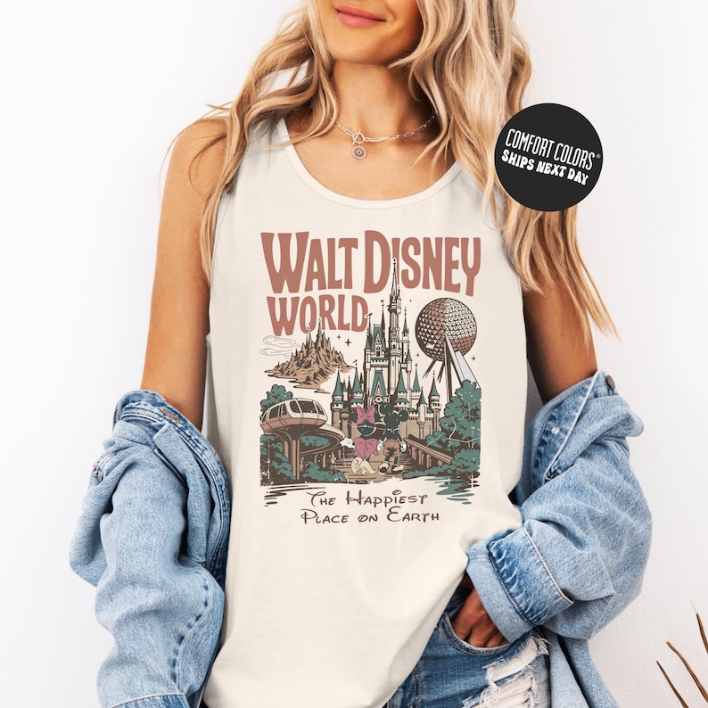 A woman wearing a white tank top with a graphic of Walt Disney World and the text "The Happiest Place on Earth" printed on it.