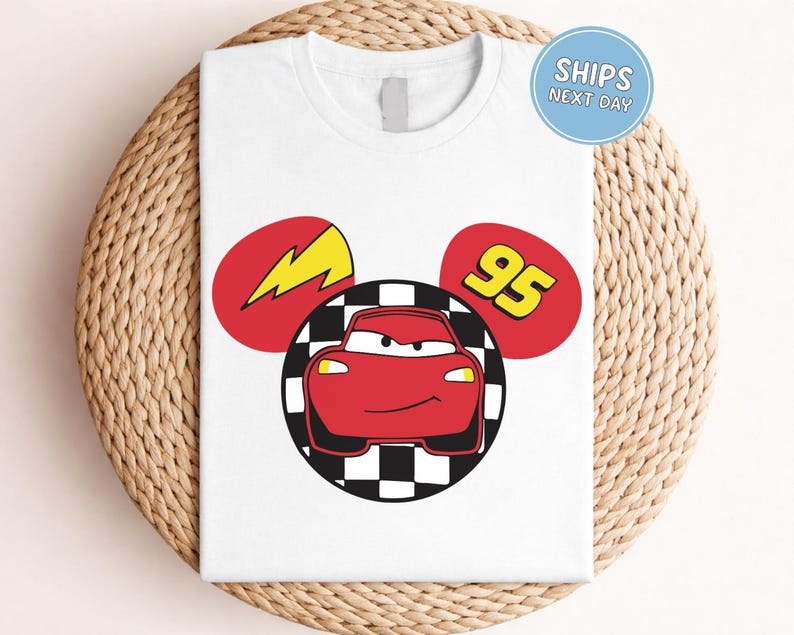 A white t-shirt with a graphic design featuring a red car and a lightning bolt, along with the number 95.