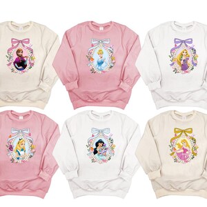 a set of four sweatshirts with princesses on them