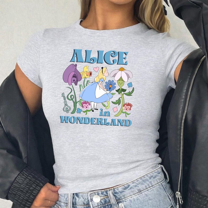 A gray t-shirt with a graphic design featuring a character from the "Alice in Wonderland" series.