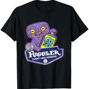 May include: A black t-shirt with a purple, glittery monster holding a spray can with the words "FUGGLER" and "FUNNY UGLY MONSTER" printed on it.