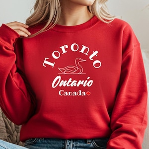 Toronto, Ontario, Canadá, Loon Maple Leaf, sudadera con capucha y codos hacia arriba, orgullo canadiense, cultura canadiense, norte verdadero, fuerte y libre.