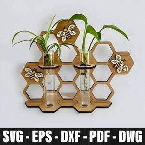 May include: Wooden honeycomb-shaped wall planter with three glass test tube vases. The planter features decorative wooden bees and holds green plants. The bottom of the image displays the text "SVG - EPS - DXF - PDF - DWG".