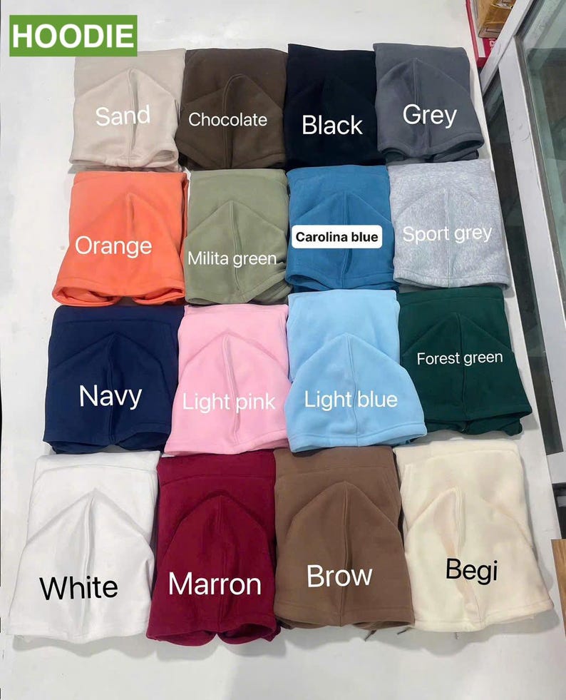 May include: A collection of hoodies in various colors, including sand, chocolate, black, grey, orange, milita green, carolina blue, sport grey, navy, light pink, light blue, forest green, white, marron, brow, and begi. The word "HOODIE" is at the top.