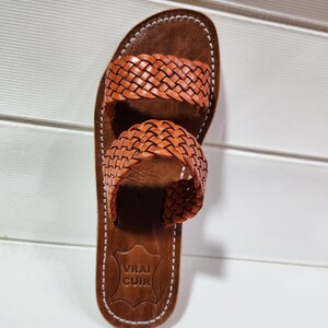 woven leather sandals, moroccan leather sandals, boho sandals women, brown leather sandals, braided leather sandals, artisan flat shoes, moroccan slides, handmade slippers women, summer beach sandals, bohemian leather sandals, real leather sandals, flat moroccan sandals, comfy summer shoes, leather sandals for women, vacation sandals, moroccan fashion shoes, traditional moroccan slippers, stylish flat sandals, rustic leather shoes, braided slide sandals, slip on boho sandals, boho flat leather