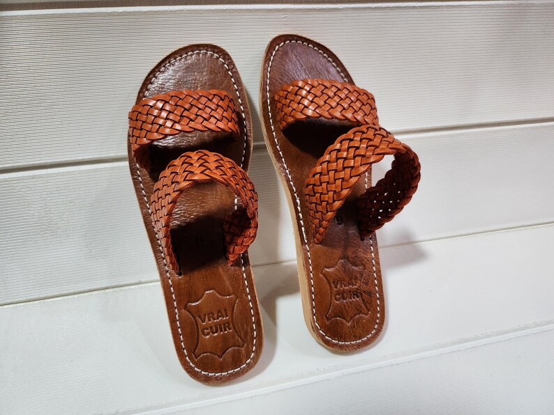 woven leather sandals, moroccan leather sandals, boho sandals women, brown leather sandals, braided leather sandals, artisan flat shoes, moroccan slides, handmade slippers women, summer beach sandals, bohemian leather sandals, real leather sandals, flat moroccan sandals, comfy summer shoes, leather sandals for women, vacation sandals, moroccan fashion shoes, traditional moroccan slippers, stylish flat sandals, rustic leather shoes, braided slide sandals, slip on boho sandals, boho flat leather