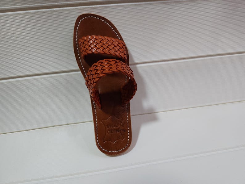woven leather sandals, moroccan leather sandals, boho sandals women, brown leather sandals, braided leather sandals, artisan flat shoes, moroccan slides, handmade slippers women, summer beach sandals, bohemian leather sandals, real leather sandals, flat moroccan sandals, comfy summer shoes, leather sandals for women, vacation sandals, moroccan fashion shoes, traditional moroccan slippers, stylish flat sandals, rustic leather shoes, braided slide sandals, slip on boho sandals, boho flat leather