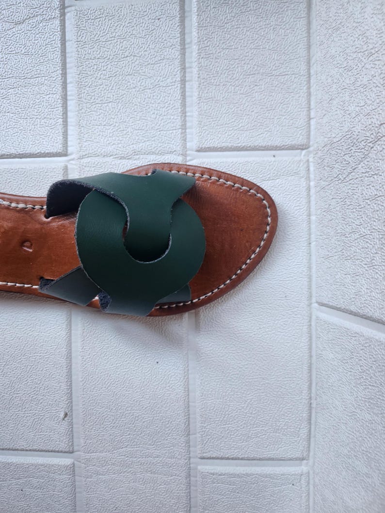 leather sandals women, Moroccan green sandals, handmade summer slides, women’s boho sandals, flat leather slippers, forest green leather, artisanal Moroccan footwear, beach sandals women, vacation sandals, open toe leather flats, brown sole sandals, soft leather shoes, Moroccan artisan slides, barefoot minimalist shoes, green leather sandals, summer flat shoes, natural leather flats, handmade casual sandals, slip-on sandals leather, handcrafted women shoes, Moroccan twist strap sandals