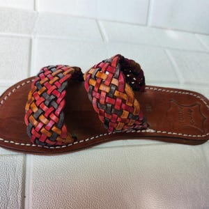 moroccan sandals, handmade sandals, boho sandals women, braided sandals, leather slides women, summer sandals, colorful leather shoes, open toe leather flats, leather shoes for women, slip on summer sandals, beach sandals women, casual leather sandals, flat sandals women, artisan sandals, moroccan shoes, ethnic leather sandals, barefoot sandals, rustic leather shoes, women’s holiday shoes, strappy leather slides, leather footwear, earthy tone sandals, hippie sandals, gypsy sandals