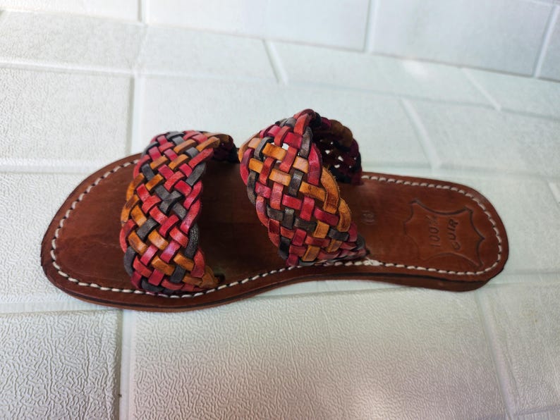 moroccan sandals, handmade sandals, boho sandals women, braided sandals, leather slides women, summer sandals, colorful leather shoes, open toe leather flats, leather shoes for women, slip on summer sandals, beach sandals women, casual leather sandals, flat sandals women, artisan sandals, moroccan shoes, ethnic leather sandals, barefoot sandals, rustic leather shoes, women’s holiday shoes, strappy leather slides, leather footwear, earthy tone sandals, hippie sandals, gypsy sandals