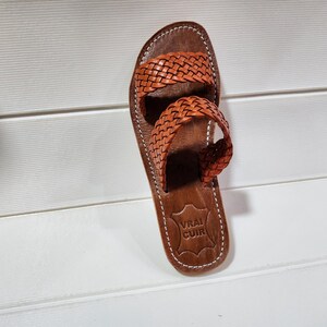 woven leather sandals, moroccan leather sandals, boho sandals women, brown leather sandals, braided leather sandals, artisan flat shoes, moroccan slides, handmade slippers women, summer beach sandals, bohemian leather sandals, real leather sandals, flat moroccan sandals, comfy summer shoes, leather sandals for women, vacation sandals, moroccan fashion shoes, traditional moroccan slippers, stylish flat sandals, rustic leather shoes, braided slide sandals, slip on boho sandals, boho flat leather