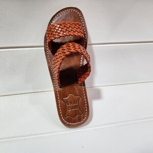 woven leather sandals, moroccan leather sandals, boho sandals women, brown leather sandals, braided leather sandals, artisan flat shoes, moroccan slides, handmade slippers women, summer beach sandals, bohemian leather sandals, real leather sandals, flat moroccan sandals, comfy summer shoes, leather sandals for women, vacation sandals, moroccan fashion shoes, traditional moroccan slippers, stylish flat sandals, rustic leather shoes, braided slide sandals, slip on boho sandals, boho flat leather
