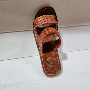 woven leather sandals, moroccan leather sandals, boho sandals women, brown leather sandals, braided leather sandals, artisan flat shoes, moroccan slides, handmade slippers women, summer beach sandals, bohemian leather sandals, real leather sandals, flat moroccan sandals, comfy summer shoes, leather sandals for women, vacation sandals, moroccan fashion shoes, traditional moroccan slippers, stylish flat sandals, rustic leather shoes, braided slide sandals, slip on boho sandals, boho flat leather