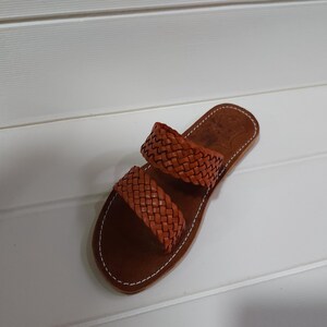 woven leather sandals, moroccan leather sandals, boho sandals women, brown leather sandals, braided leather sandals, artisan flat shoes, moroccan slides, handmade slippers women, summer beach sandals, bohemian leather sandals, real leather sandals, flat moroccan sandals, comfy summer shoes, leather sandals for women, vacation sandals, moroccan fashion shoes, traditional moroccan slippers, stylish flat sandals, rustic leather shoes, braided slide sandals, slip on boho sandals, boho flat leather
