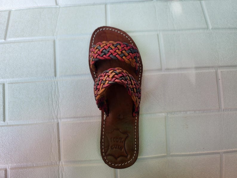 moroccan sandals, handmade sandals, boho sandals women, braided sandals, leather slides women, summer sandals, colorful leather shoes, open toe leather flats, leather shoes for women, slip on summer sandals, beach sandals women, casual leather sandals, flat sandals women, artisan sandals, moroccan shoes, ethnic leather sandals, barefoot sandals, rustic leather shoes, women’s holiday shoes, strappy leather slides, leather footwear, earthy tone sandals, hippie sandals, gypsy sandals
