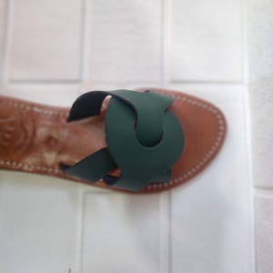 leather sandals women, Moroccan green sandals, handmade summer slides, women’s boho sandals, flat leather slippers, forest green leather, artisanal Moroccan footwear, beach sandals women, vacation sandals, open toe leather flats, brown sole sandals, soft leather shoes, Moroccan artisan slides, barefoot minimalist shoes, green leather sandals, summer flat shoes, natural leather flats, handmade casual sandals, slip-on sandals leather, handcrafted women shoes, Moroccan twist strap sandals
