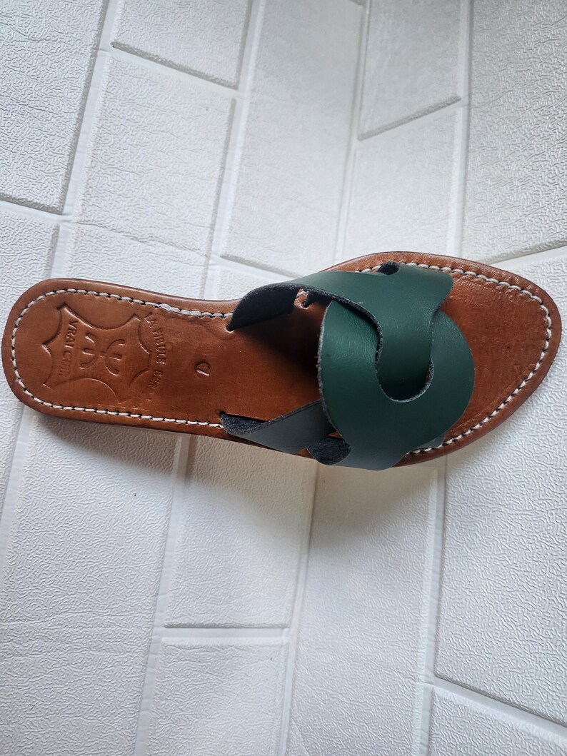 leather sandals women, Moroccan green sandals, handmade summer slides, women’s boho sandals, flat leather slippers, forest green leather, artisanal Moroccan footwear, beach sandals women, vacation sandals, open toe leather flats, brown sole sandals, soft leather shoes, Moroccan artisan slides, barefoot minimalist shoes, green leather sandals, summer flat shoes, natural leather flats, handmade casual sandals, slip-on sandals leather, handcrafted women shoes, Moroccan twist strap sandals