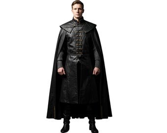 May include: A full-length image of a person wearing a black leather coat with a matching cape. The coat features decorative gold-colored clasps and a high collar. The person is wearing black boots and pants.