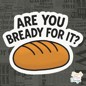以下が含まれることがあります： 「ARE YOU BREADY FOR IT？」の文字とパンのイラストが描かれたステッカー。パンはオレンジ色で、茶色の線が入っています。背景は新聞の印刷です。