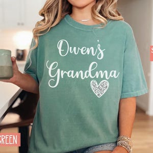 May include: Light green t-shirt with the text "Owen's Grandma" and a sparkly heart.