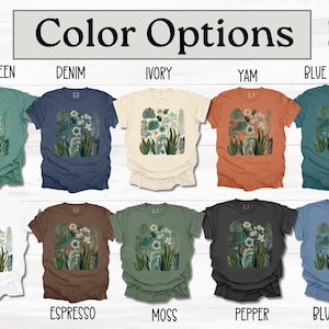 May include: T-shirts in a range of colours, each with a floral design. Colours include light green, denim, ivory, yam, blue spruce, white, espresso, moss, pepper, and blue jean. The text "Color Options" is displayed at the top.