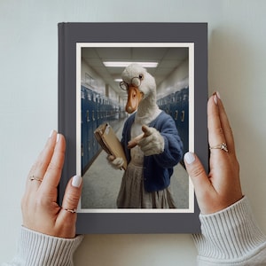 May include: A dark gray hardcover book featuring a central image of a white goose wearing round glasses, a blue cardigan, and a skirt, holding a tan folder while pointing forward in a school hallway with blue lockers on both sides.
