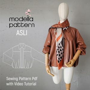 May include: A brown leather jacket with a collared neckline and a scarf with orange, black, and white patterns is displayed on a mannequin. The text "modella pattern ASLI" and "Sewing Pattern Pdf with Video Tutorial" are visible.
